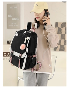 Fashionable black and white backpack with pink sport straps worn by a model