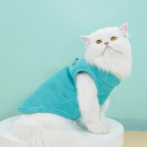 Macro detail of teal fleece warm dog vest featuring metal D-ring for leash attachment
