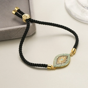 Close-up of evil eye charm bracelet with blue zircon stones and adjustable black cord
