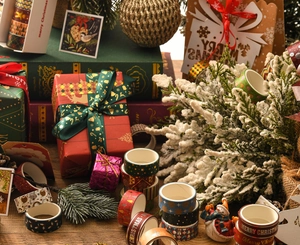 Close-up of festive Christmas washi tape rolls featuring gold stamping and snowflakes