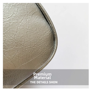 Macro view of silver-gray bag showing premium oil-wax wrinkled texture and edge craftsmanship