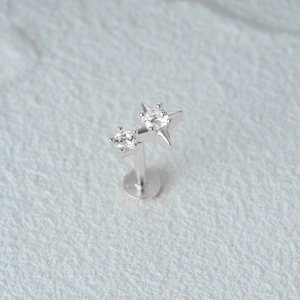 Macro view of sterling silver star stud earring with shimmering zircon gemstones