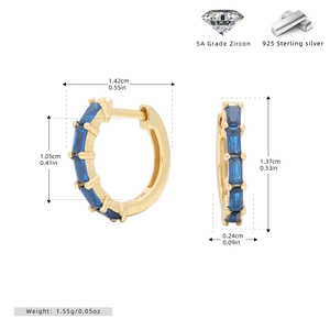 Detail view of gold 925 sterling silver hoop earrings with blue square zircon and specs
