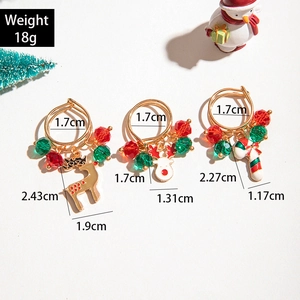 Three-piece Christmas ring set with elk, cane, and bell charms in gold alloy finish