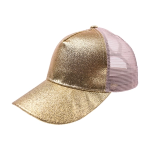 Close-up of glitter gold sequins and breathable mesh fabric on a stylish trucker hat