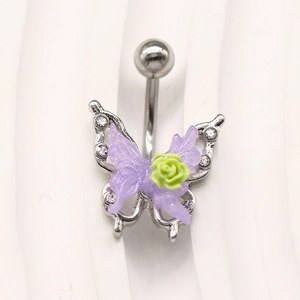 Macro shot of silver butterfly belly ring with purple wings and green rose detail