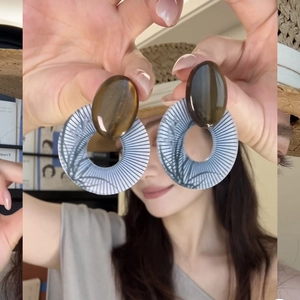 Exaggerated geometric earrings with brown oval resin and black-white striped hoops