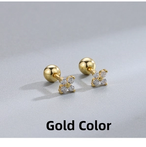 Detail view of gold clover stud earrings with cubic zirconia and screw back closure