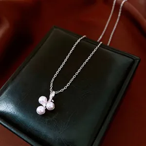 French minimalist stainless steel necklace with pearl cluster pendant and zircon detail