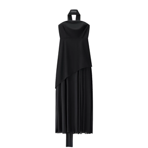 Detail of the sheer mesh patchwork hem and asymmetric cut on the black halter dress