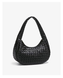 Close-up of black woven leather handbag with intricate Intrecciato pattern and texture