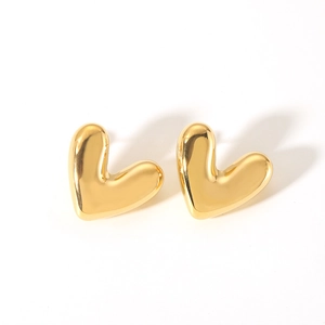 Close-up of polished 18K gold plated heart stud earrings with smooth metallic finish
