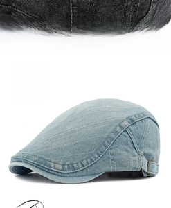 Detail of light blue washed denim beret with adjustable metal side buckle closure