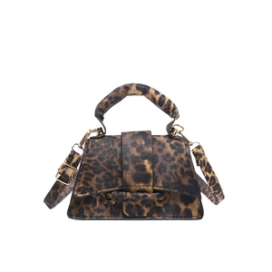 Fashionable leopard print trapezoid handbag with gold hardware and crossbody strap