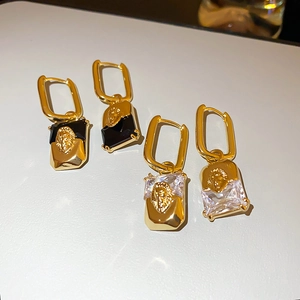 Detailed macro view of vintage lion head earrings with rectangular crystal stones