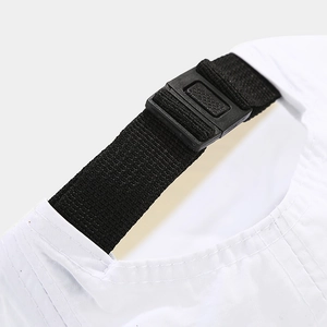 Detailed view of the adjustable black nylon strap and plastic buckle on a white baseball cap