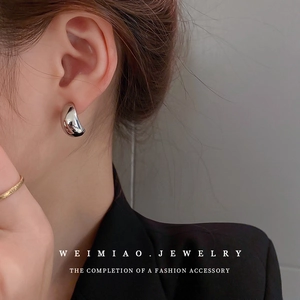 Chic silver water drop C-shaped stud earrings shown on model for a minimalist style