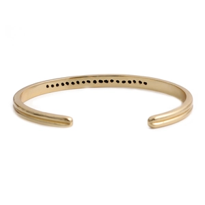 Polished gold cuff bracelet with cubic zirconia micro-inlays and minimalist open design