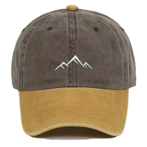 Detailed embroidery of mountain lines on a vintage washed two-tone baseball cap
