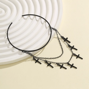 Detailed close-up of a black gothic choker with multiple layered cross charms on a stand