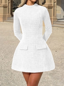 Detailed texture of white tweed fabric on an A-line long-sleeved elegant dress