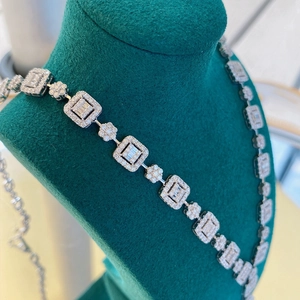 Detail of silver luxury necklace with square and flower links set in full crystals