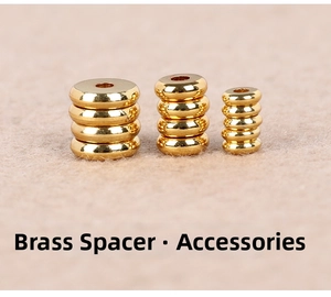 Stack of three sizes of golden brass spacer beads for jewelry and prayer beads
