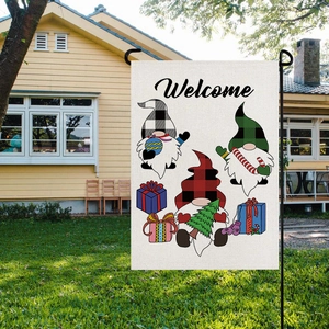 Detail of Christmas garden flag with gnomes and Welcome text on linen fabric