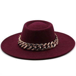 Detail showing the burgundy felt texture and chunky gold chain on this flat top fedora