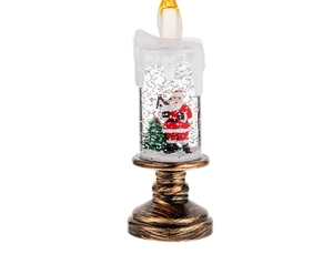 Detail of Santa Claus inside a LED snow globe candle with sparkling silver glitter