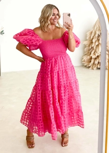 Detail of off-shoulder puff sleeves and shirred bodice on hot pink maxi dress