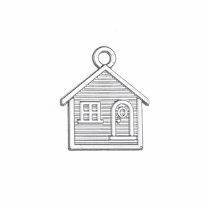 Detailed close-up of an antique silver house pendant with loop for DIY jewelry making