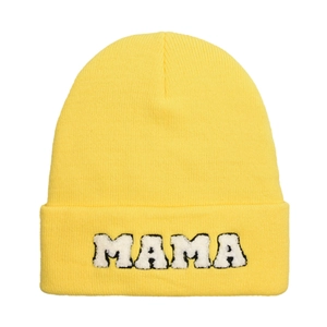 Detailed close-up of yellow knit beanie featuring bold white MAMA embroidered letters