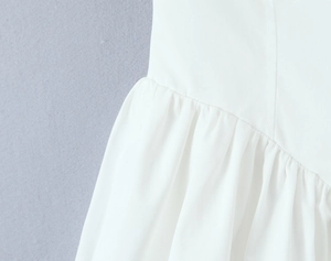 Detailed close-up showing the textured fabric and pleated seams of this white French dress