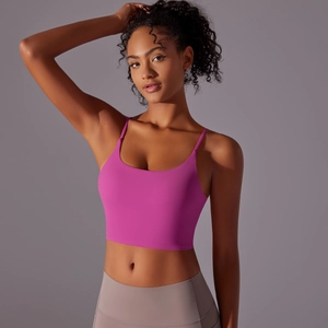 Detail of high-impact rose pink sports bra with thin straps and elastic nylon fabric
