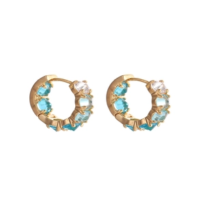 Elegant gold earrings with alternating light blue and white crystals on white background