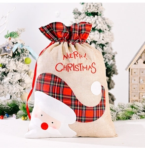 Detail of Christmas burlap gift bag with plaid Santa applique and Merry Christmas embroidery