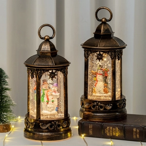 Vintage bronze Christmas lantern with illuminated snow globe featuring cute snowmen inside