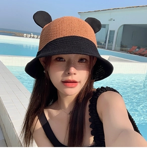Detail of creative bucket hat with animal ears and wide brim shown at outdoor pool