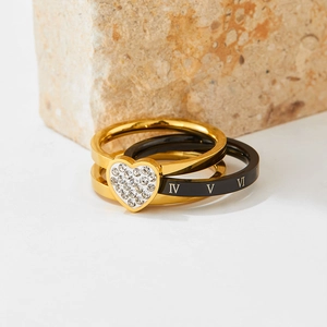 Rotating Roman numeral ring set with heart-shaped pave crystals on natural stones