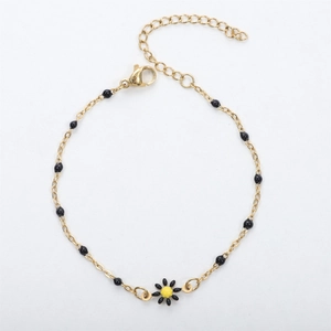 Detail of 18K gold daisy bracelet featuring black enamel beads and adjustable lobster clasp