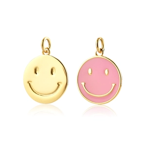 Detail of pink enamel and gold smiley face pendants on a white background with reflections