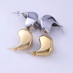 Polished gold and silver liquid lava drop earrings in a minimalist metallic teardrop style