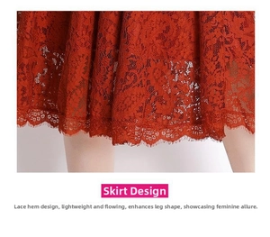 Detail of elegant orange lace dress featuring intricate floral embroidery and hollow-out hem