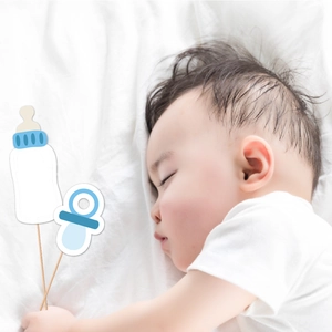 Sleeping baby holding blue baby shower photo props with pacifier and bottle shapes