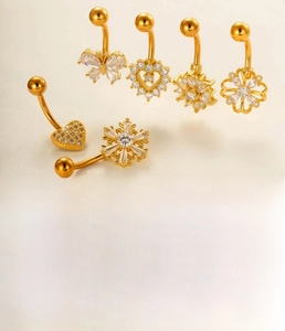 Detail of diverse navel rings with butterfly and heart shapes in gold and silver finish