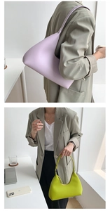 Close-up of lilac and neon green PU leather hobo bags in trendy half-moon shape