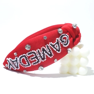 Detail of red knotted headband featuring GAME DAY beadwork and sparkling rhinestones
