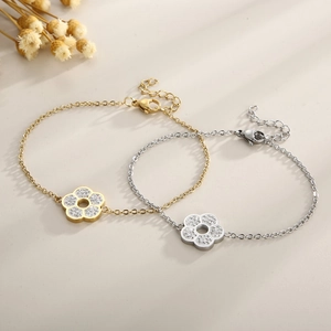 Detail of gold and silver flower bracelets with sparkling rhinestones on delicate O-chains
