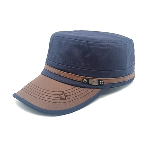 Detail of navy canvas military cap with brown faux leather brim and star embroidery